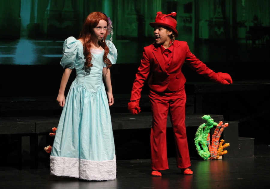 Children on stage playing Ariel and Sebastien from The Little Mermaid