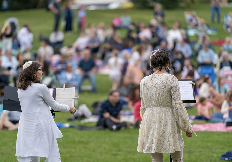 Two Jewish women giving speeches to a crowd outdoors