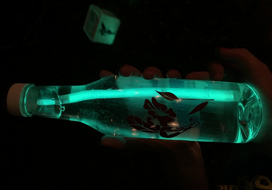 Display showing a glow stick inside a bottle