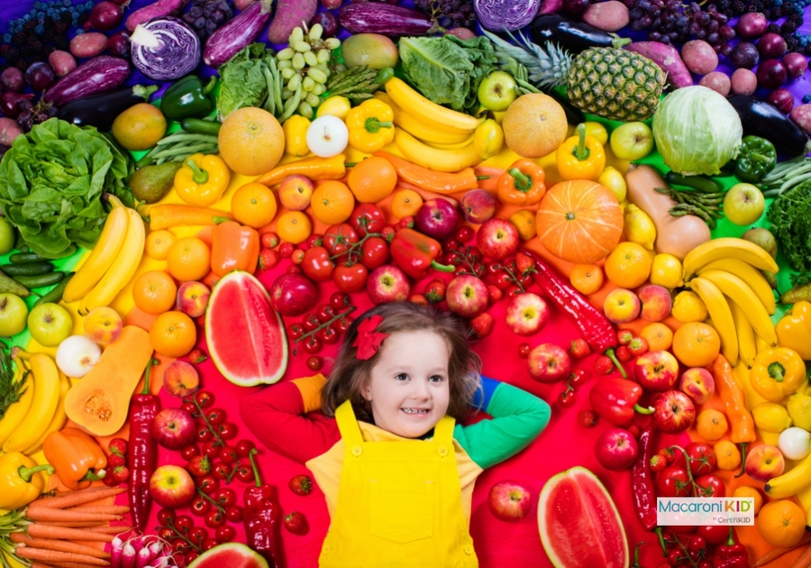 Kid with fruit and vegetable rainbow
