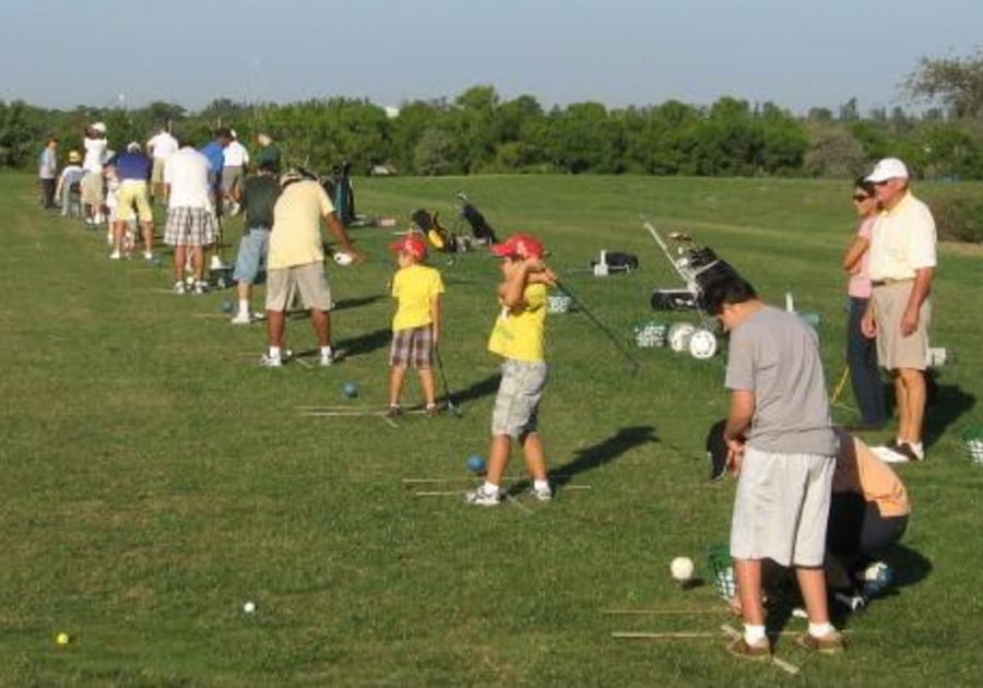 HB Golf Kids practicing golf on driving rance