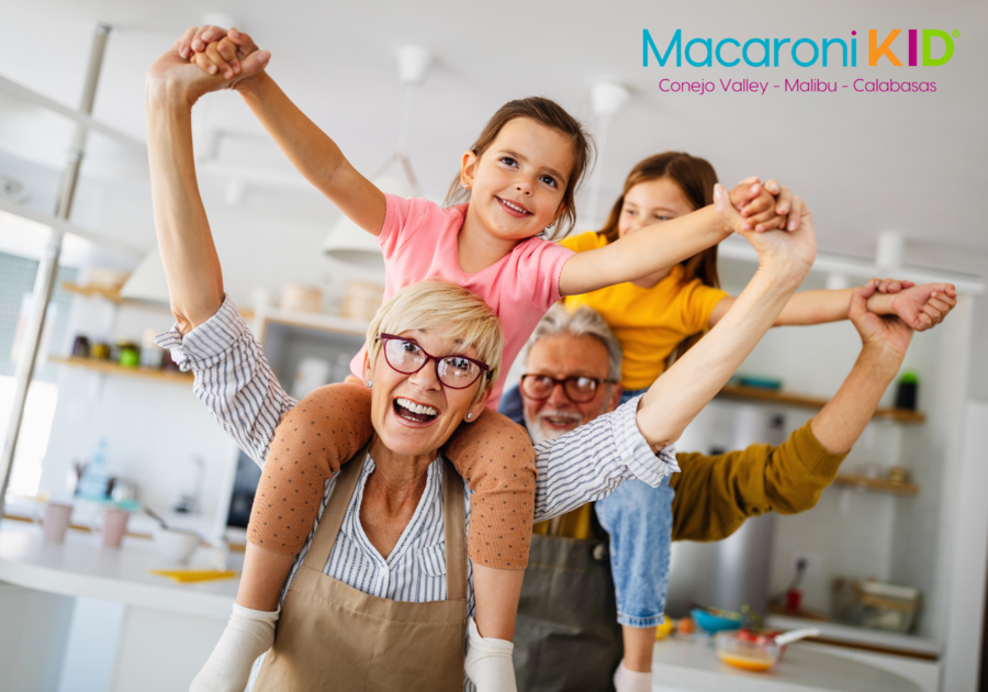 Grandma and Grandpa with kids on their shoulders all with big smiles