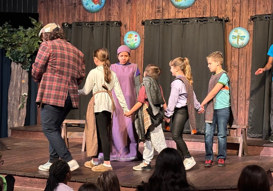 A group of children, including Roland, join the actors on stage for an interactive moment during The Golden Goose at Gamut Theatre.