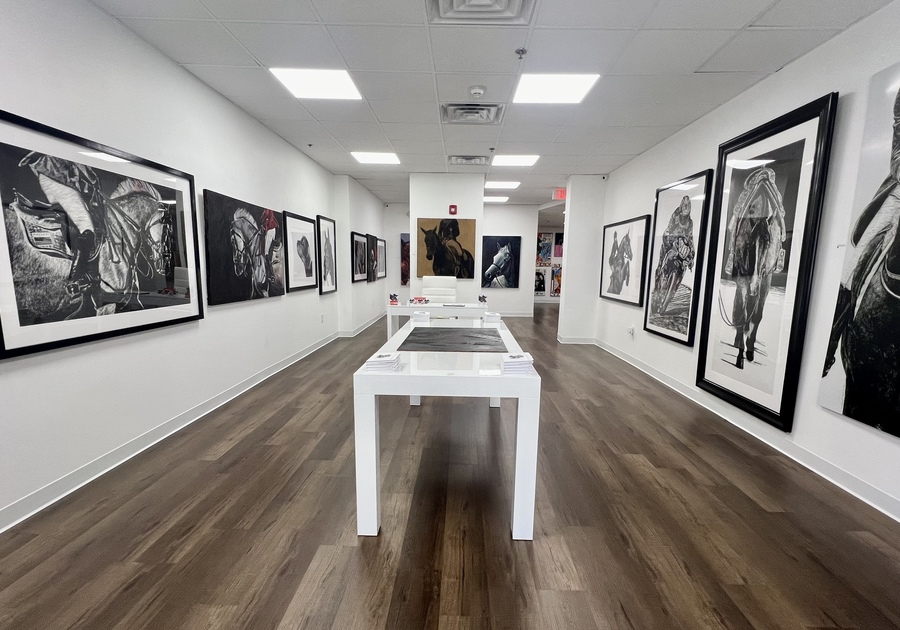 RAM Gallery - black and white framed art on all walls in a room with wooden floor
