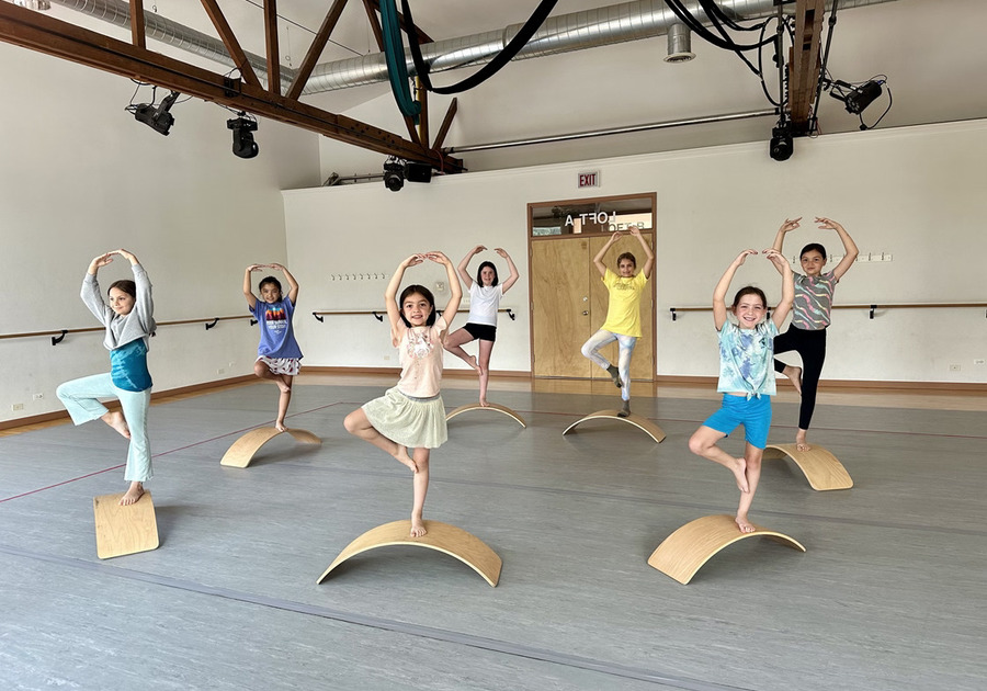 seven young girls balancing