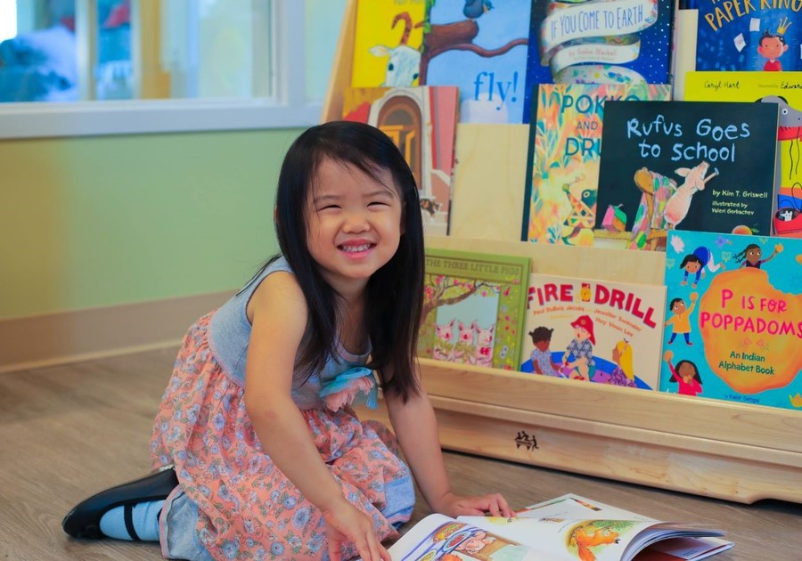 little girl reading a book