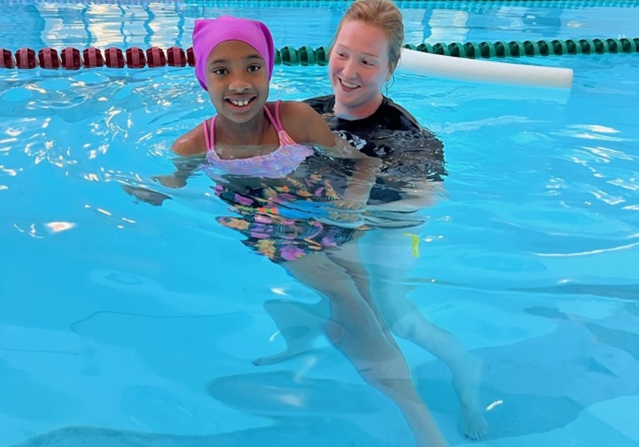 young girl in pool with woman