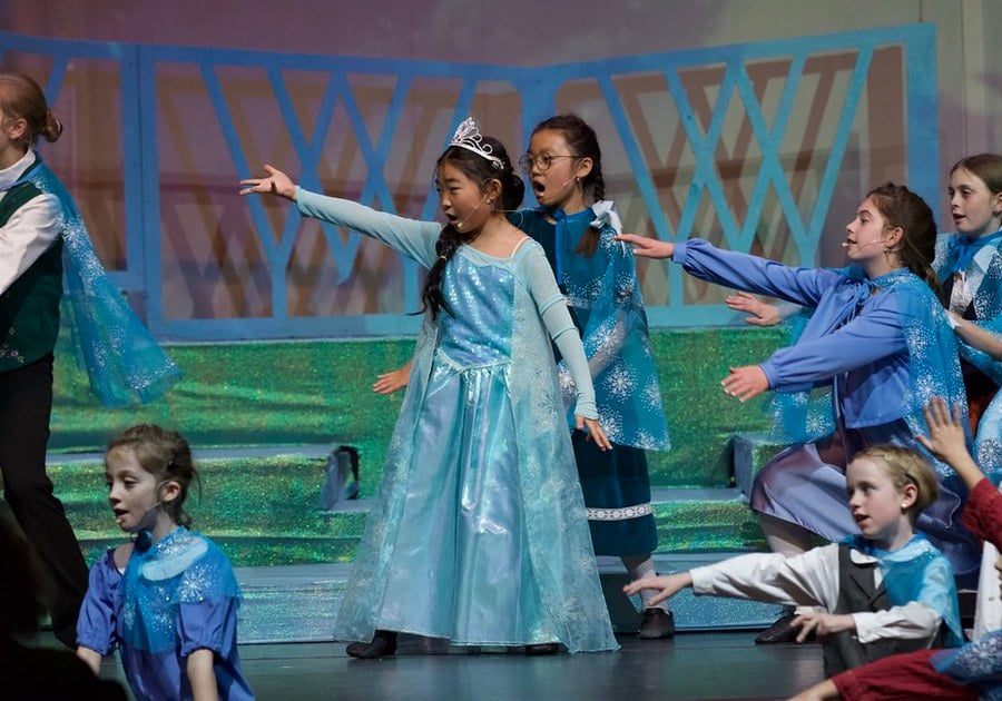 children performing on stage in a performing arts academy show