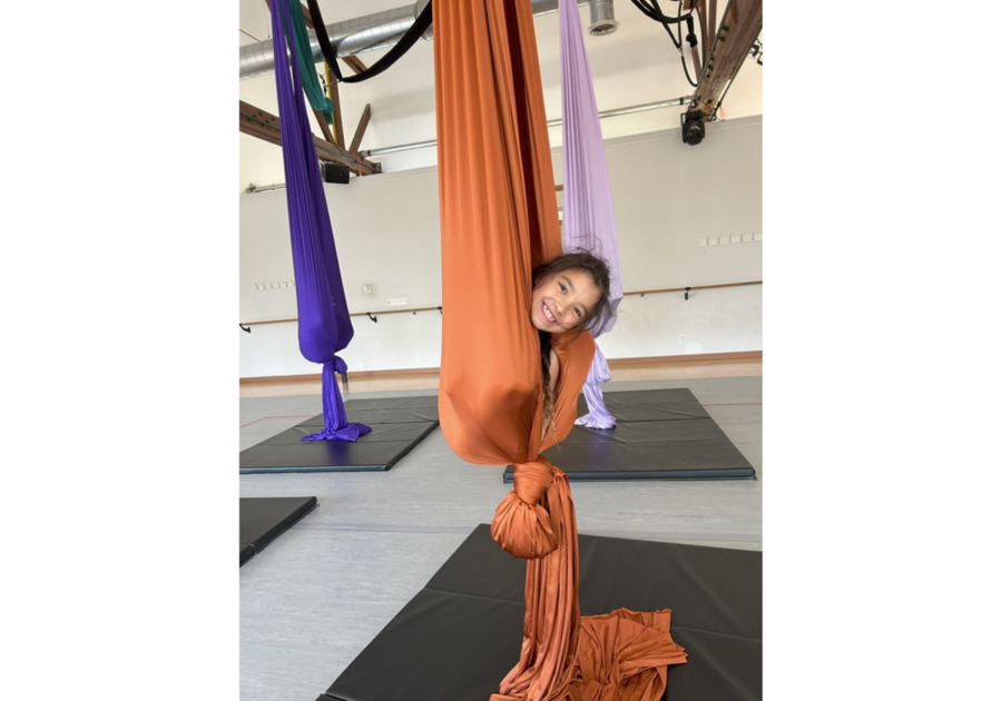 girl's head poking out of aerial silks