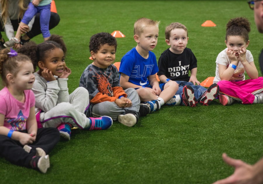 6 little kids sitting on field