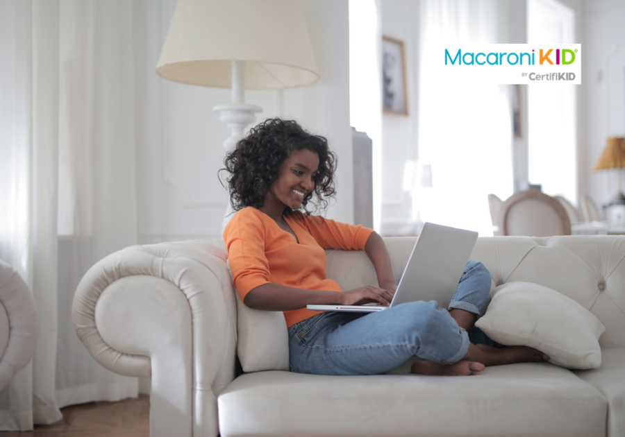 Woman Sitting on White Couch Using Laptop Computer
