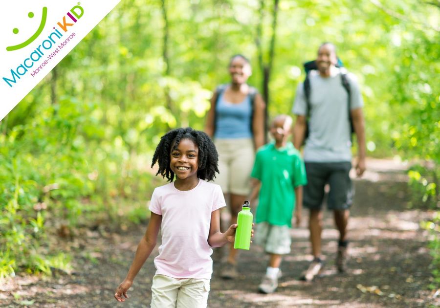 Family hiking in the woods, exploring, laughing, having fun.