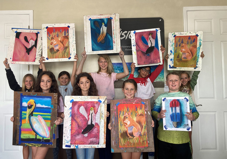 Visionary School of Arts students showing their paintings