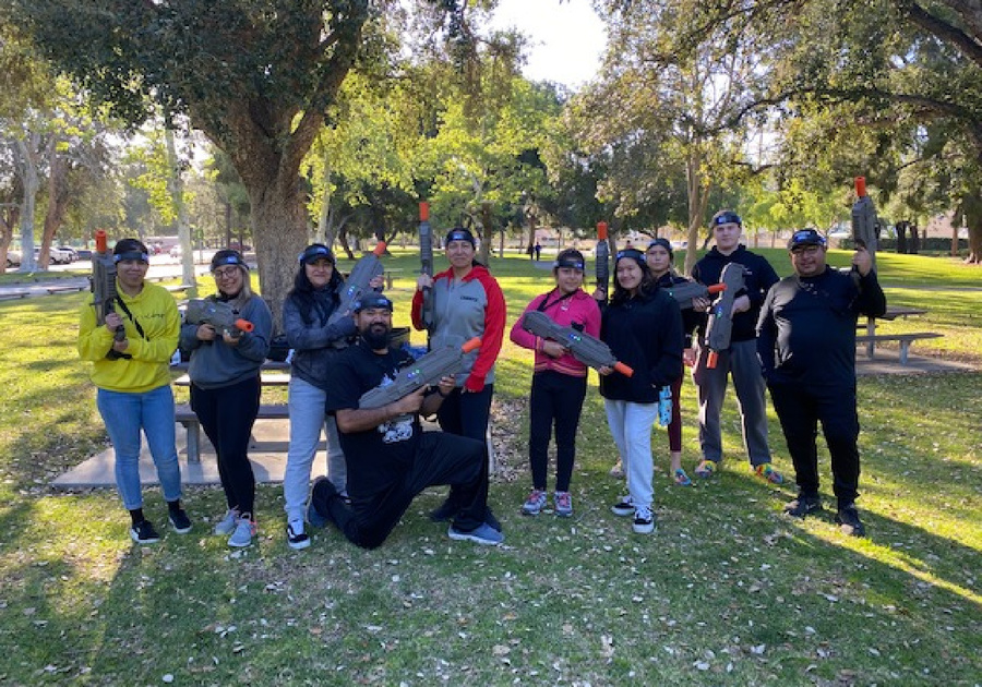 a group of people in a park getting ready to play laser tag