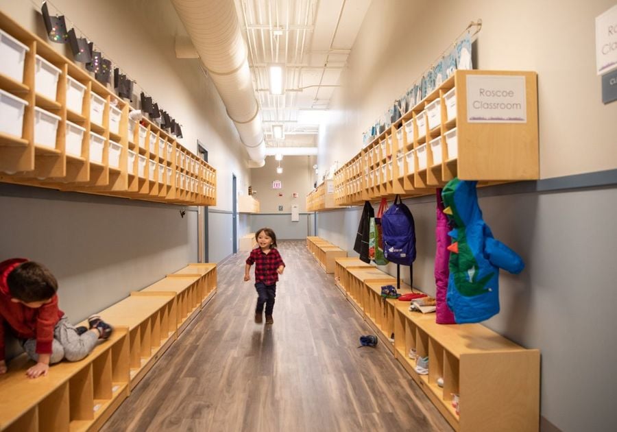 toddler running in cubby room at daycare