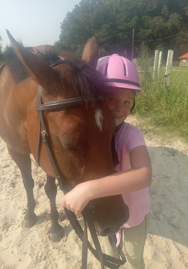 Equestrian WISH girl with horse Chesapeake VA summer camp horseback riding children learn to ride horses care for horses barn chorse