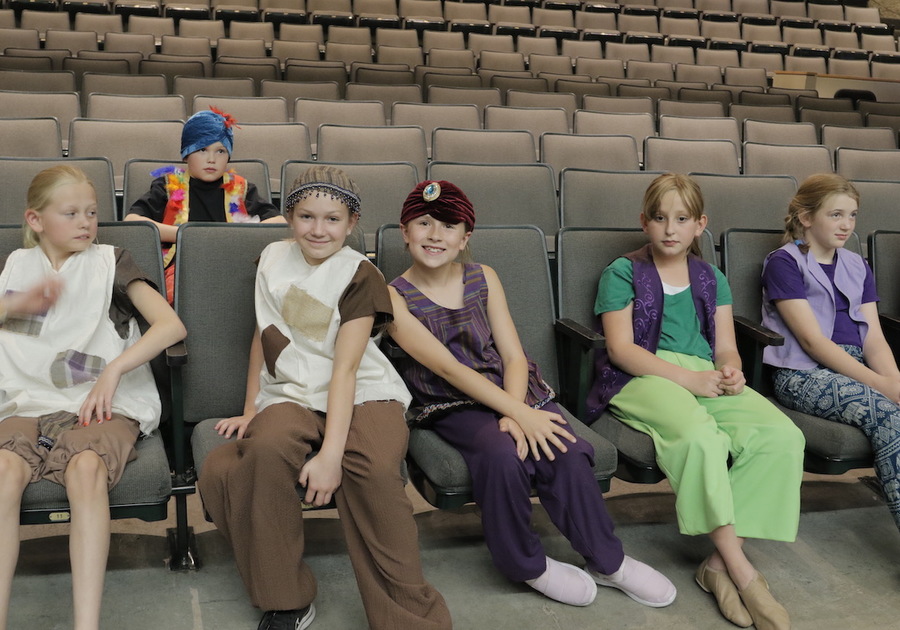 Costumed children sitting in a theater