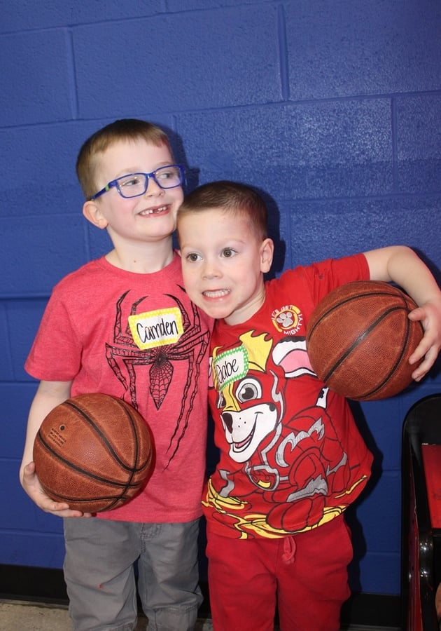 two boys holding basketballs