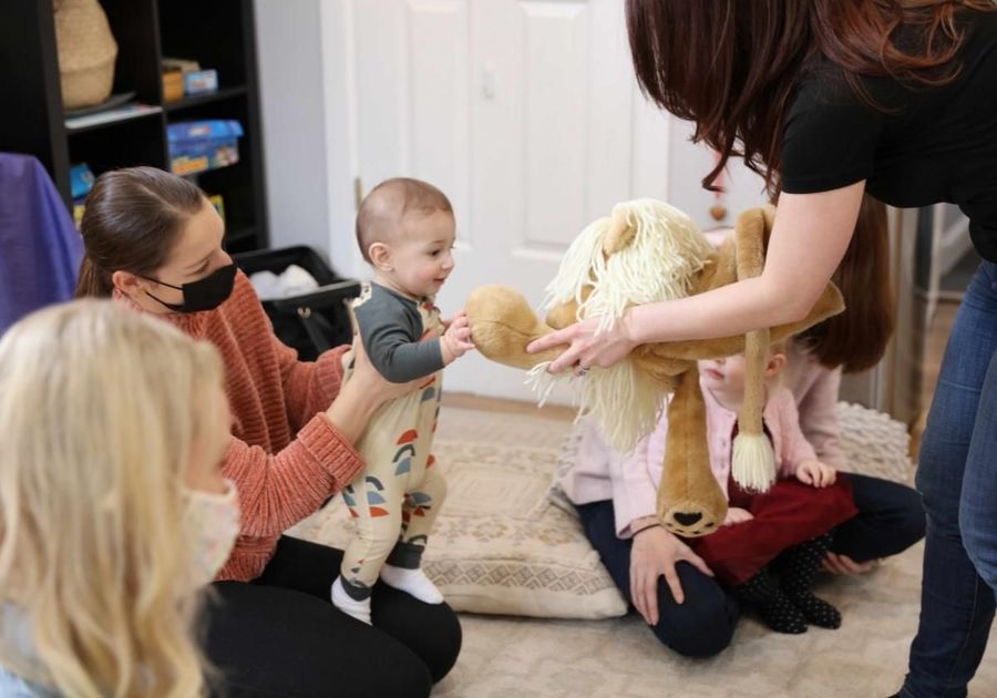 Baby playing with stuffed animal