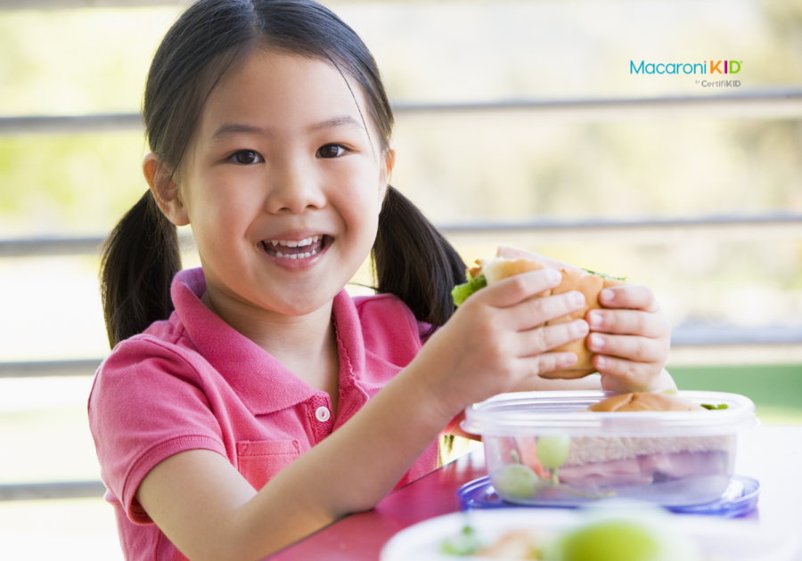 Girl Eating Lunch at Kindergarten