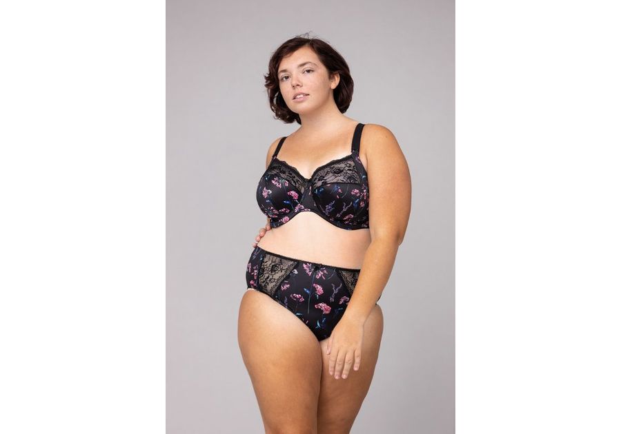 Woman in matching black with pink flowers bra and panties