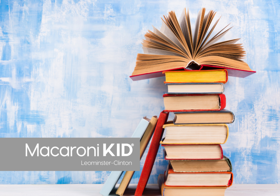 A stack of books along a blue wall.