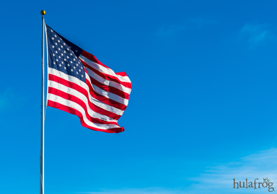 american flag waving against a blue sky