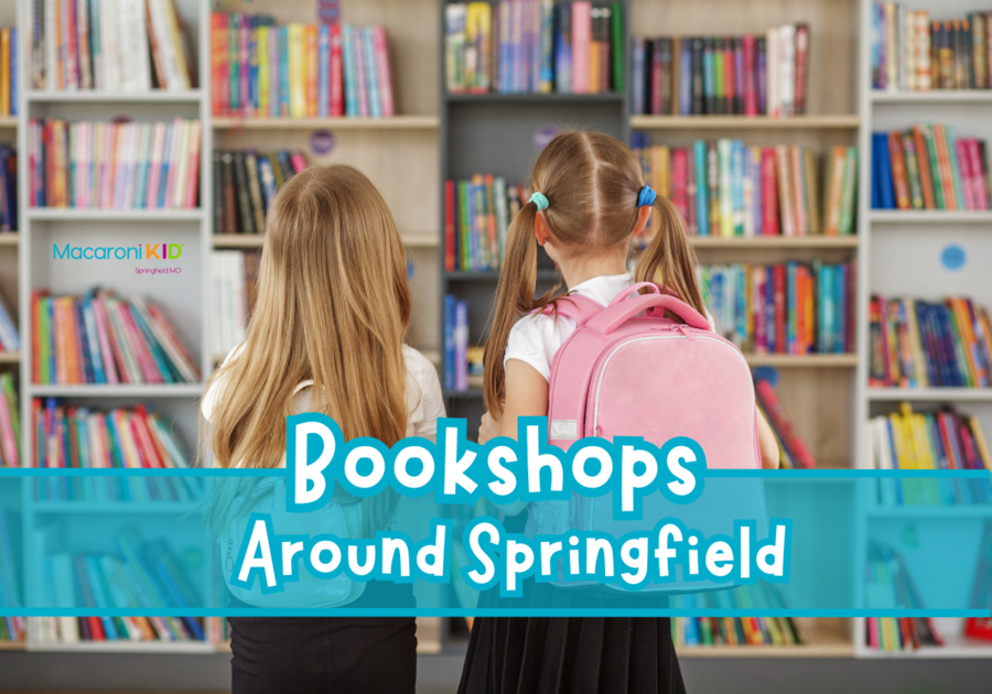 Two young girls standing in front of a large wall of shelves in a book store, displaying brightly colored book spines.