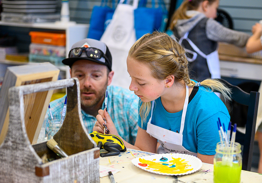dad and daughter painting a ceramic frog at Createry Workshop Highlands Ranch