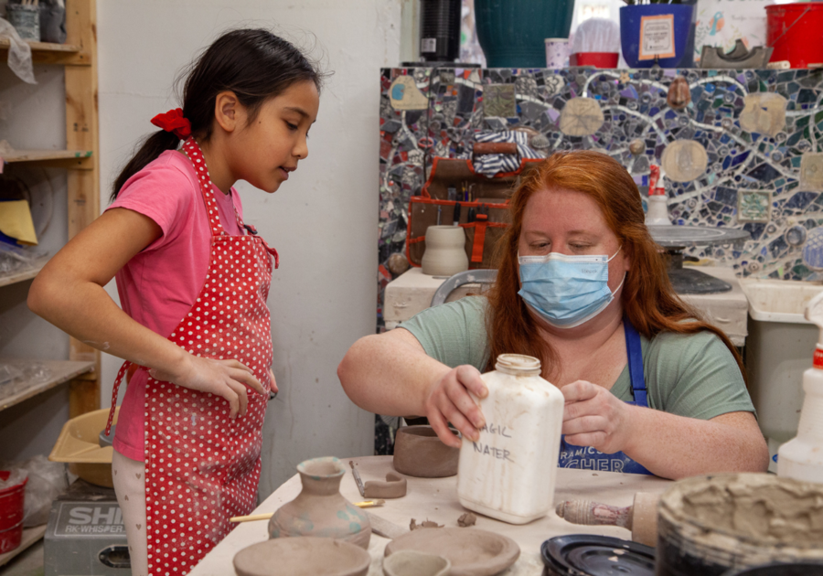 kid learning how to make pottery