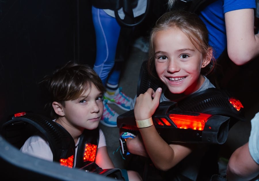 girl and boy playing laser tag
