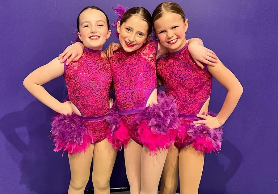 photo of young female dancers in pink posing for picture