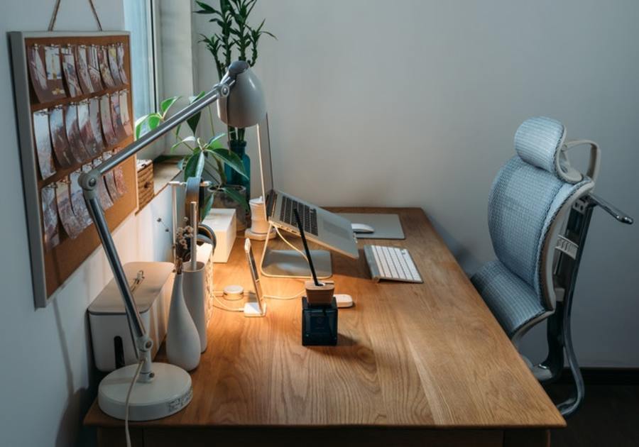  An ergonomic workspace with an adjustable desk and chair allows for a more comfortable and productive work environment.