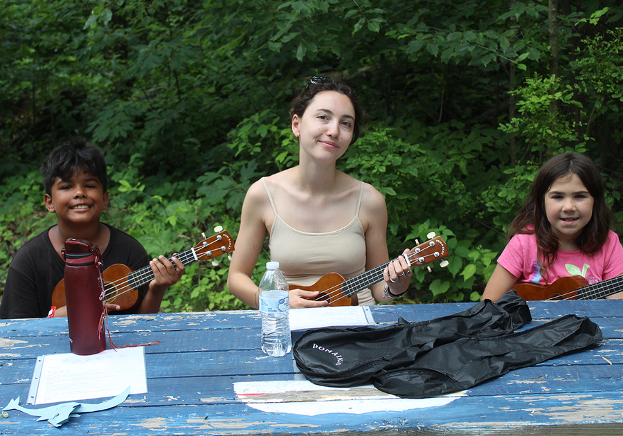 three kids playing ukelele