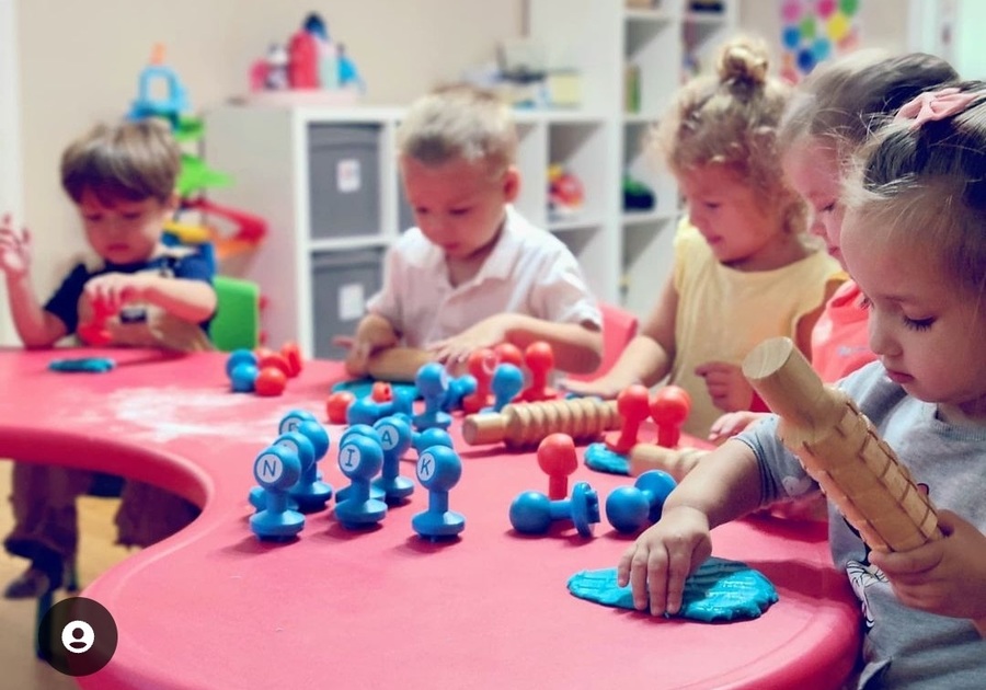 five prek kids playing with play-doh