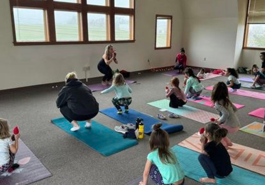 Yoga w Miss Rebecca Teacher and students doing yoga
