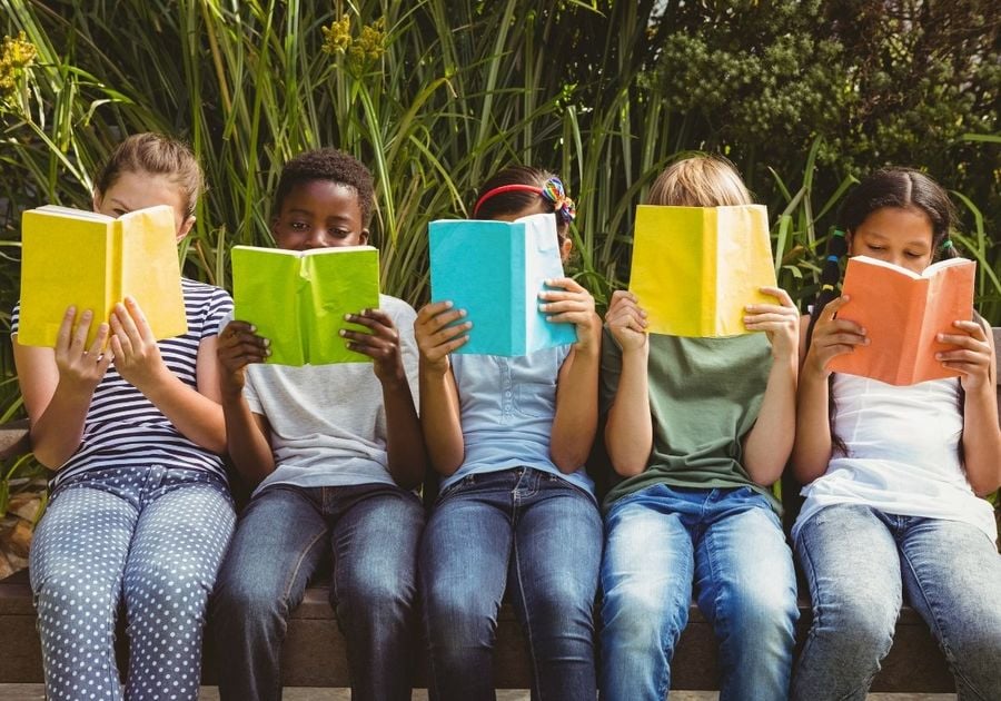 Children reading books in the park, holiday