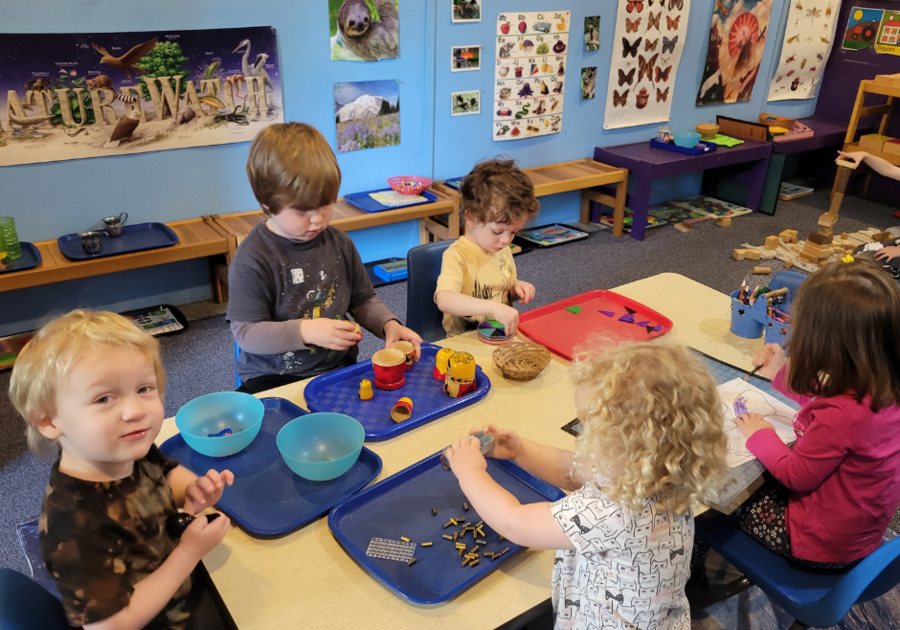 Preschool students seated at table
