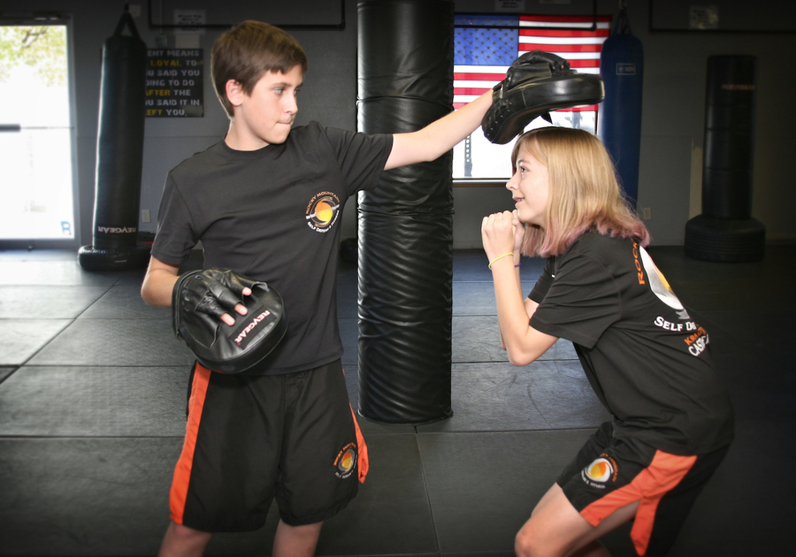 male teen and female teen practicing krav maga martial arts