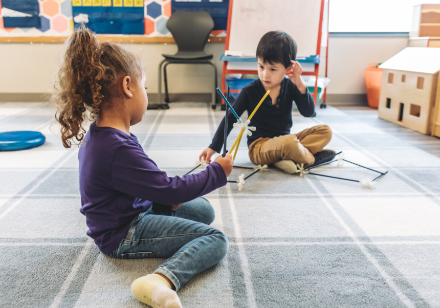 two prek kids playing with tinker toys