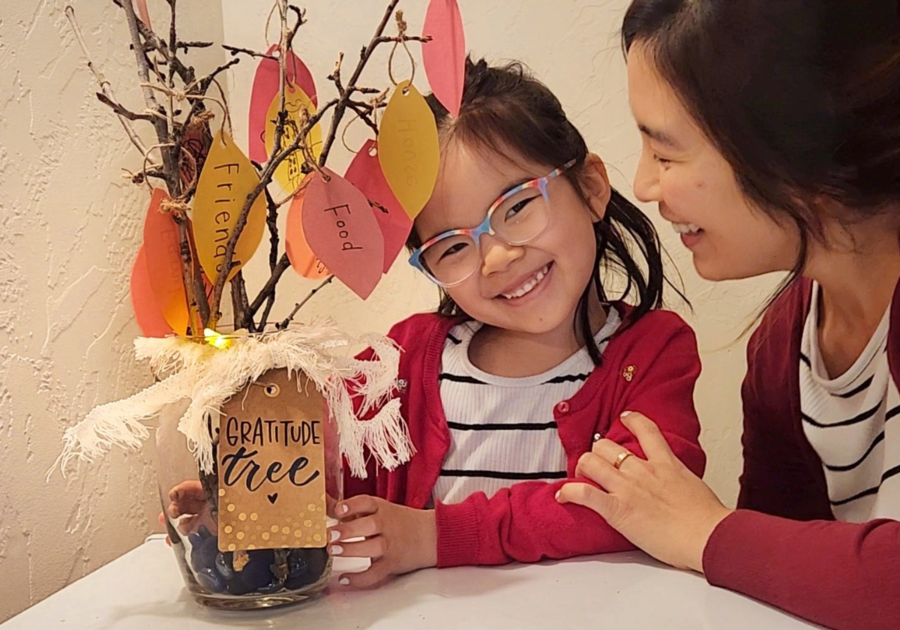 Gratitude tree with cute girl and mom