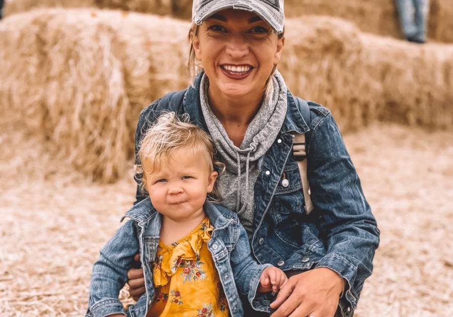 Publisher and daughter sitting on haybale