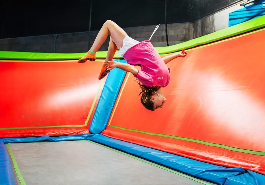 girl doing backflip on trampoline