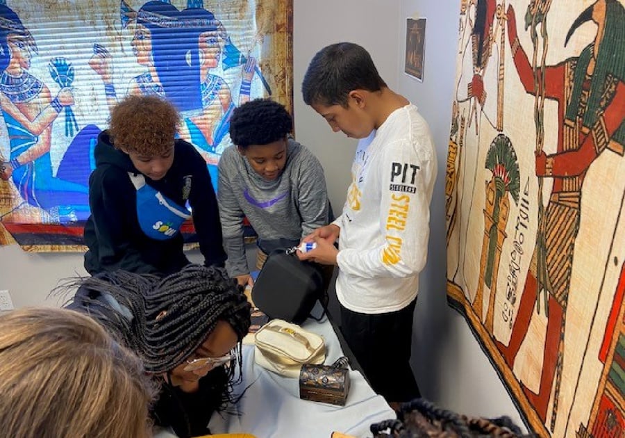 Teens solving Egyptian-themed escape room