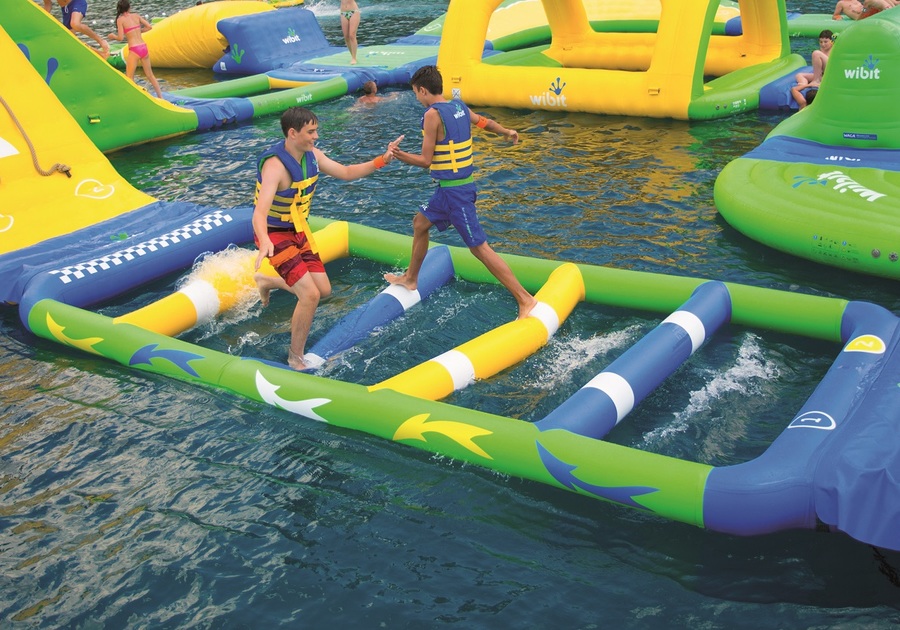 teens on floating obstacle course
