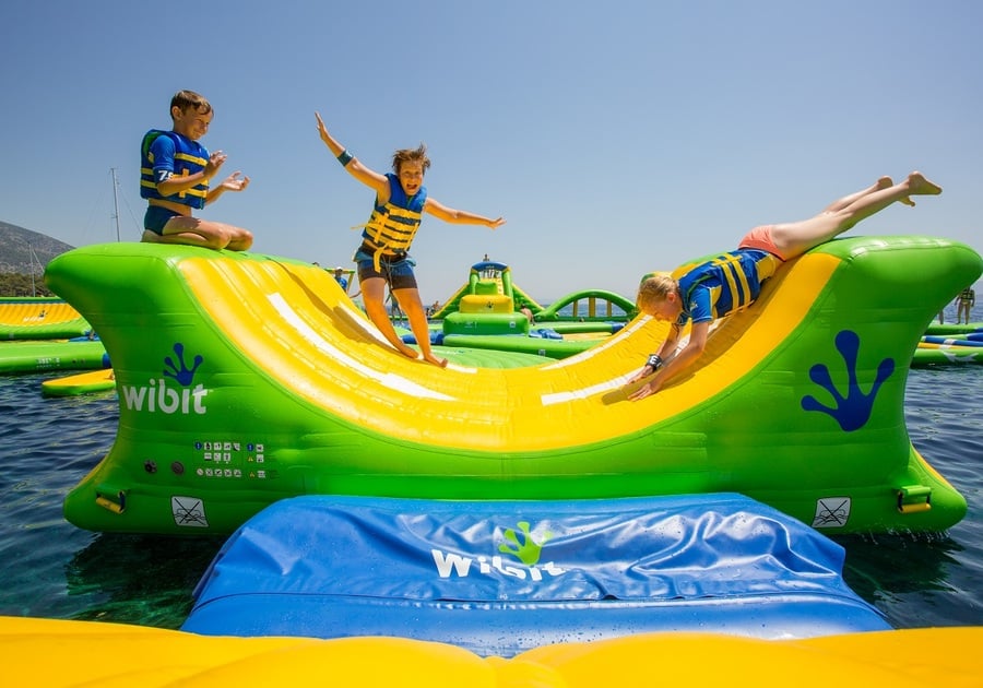 kids playing on floating obstacle course