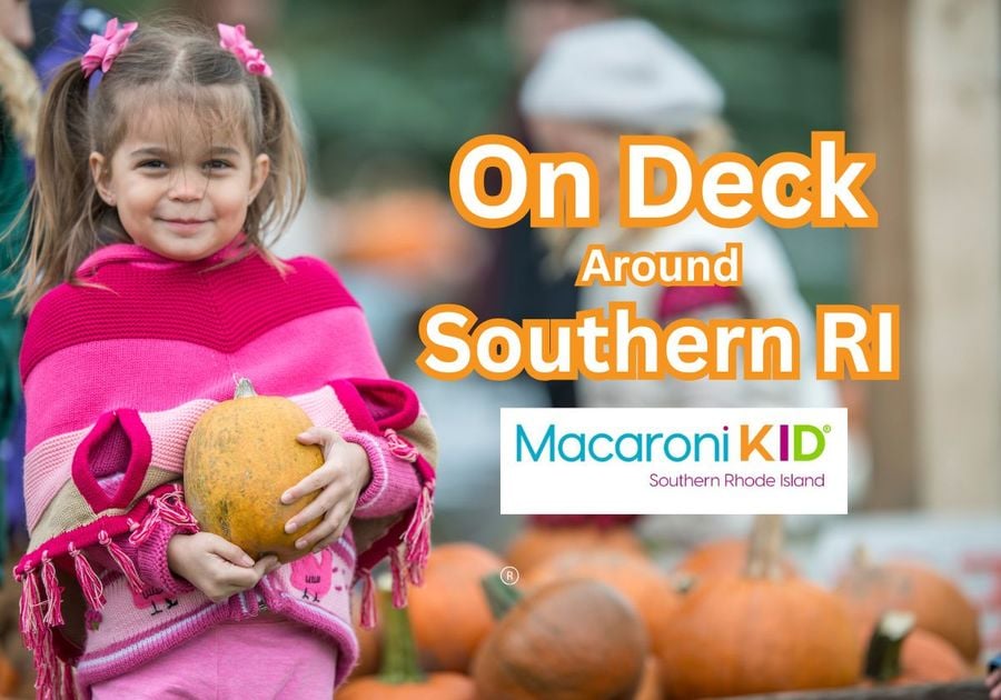 Young girl holding a pumpkin in patch