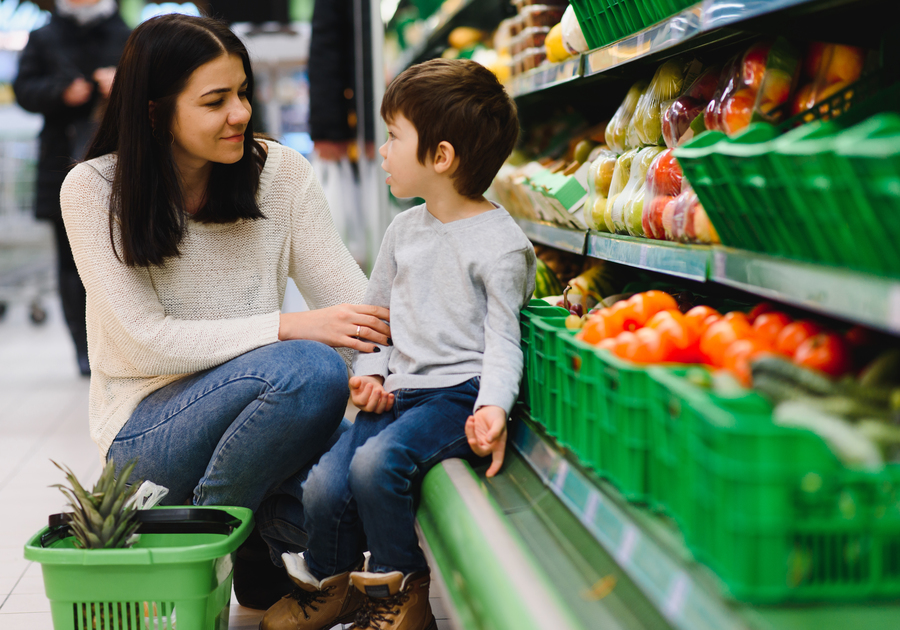 Parent and child learing about spending in grocery store