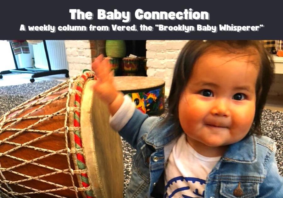 A baby hitting a drum