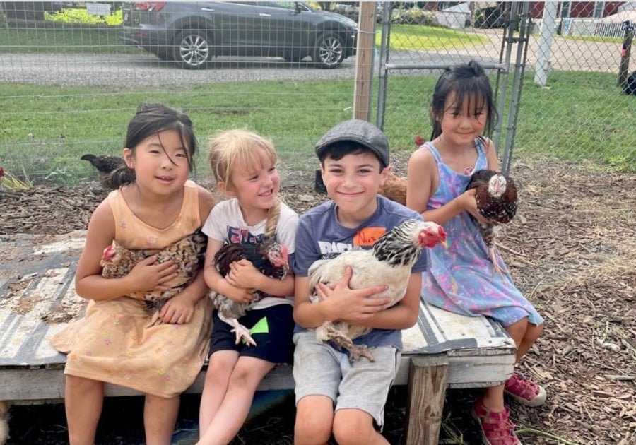 Good Pickin Farm camp kids holding animals